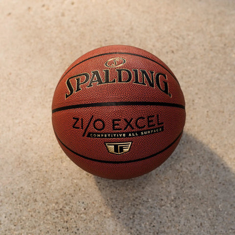 Zi O Excel Indoor Outdoor Basketball 29.5 Inch Official Size 7 with foam backed feel on a concrete surface.
