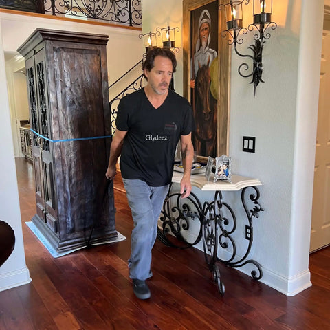 Man using Giant Appliance Slider With Pull Strap Slide Heavy Load Single Hand Shield Surfaces Easy Roll For Ovens Dishwashers Dryers Toolboxes Plus Massive Floor Glide Mat For Serious Moves Pack Of One to move heavy cabinet.