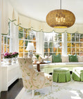 Large 22.83 Inch Rattan Boho Chandelier With Hand Woven Wicker, 4 Light Pendant Ceiling Fixture in a sunlit living room