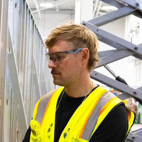 Man wearing Top Shelf Safety Glasses Featuring Anti Scratch Impact Resistant Wraparound Design With Ansi Z87 Plus High Impact Rating.