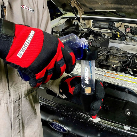 Mechanic using combustion leak detector for engine block leaks and blown head gasket tests plastic and rubber test kit