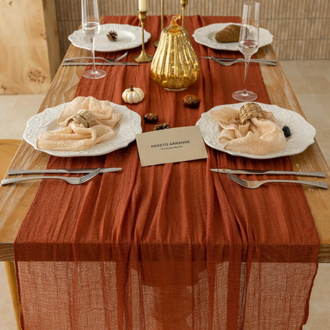 Rustic Fall Thanksgiving Table Runner Terracotta Cheesecloth Weave 120 Inches Long Hand Dyed Soft Cotton Gauze on dining table.