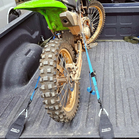 Motorbike secured with Two Pack Truck Bed Anchor Kit for Tailgate, rugged polyester webbing anchoring it on pickup bed rails.