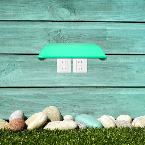 Heavy Duty Green Abs Weather Resistant Ev Charger Station Protection Box With Rock Solid Sun Shield And No Sweat Rain Guard For Outdoor Parking Lot Use mounted over outlets on a wooden wall.