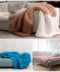Chunky blankets displayed in various colors on sofas and beds, showcasing the texture and comfort suitable for home decor.
