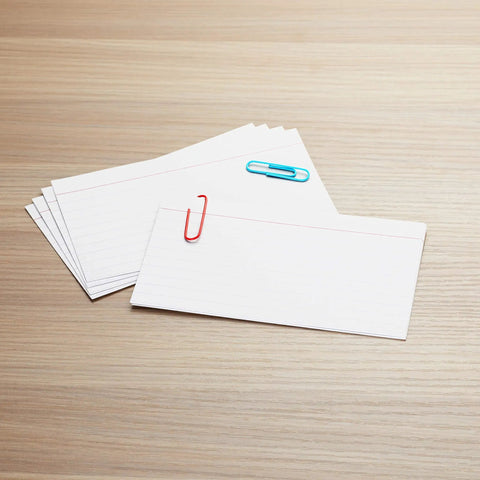 Top Shelf White Index Cards For Studying Ruled One Side Heavy Duty Notetaking Must Haves Smooth Cut Edges Perfect For Study Grinds And Quick Lists 3 By 5 Inches Bulk Pack with paperclips on a wooden surface.
