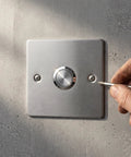 Hand installing Stainless Steel Emergency Stop Push Button Panel Mount Switch Built Like A Tank For Heavy Duty Industrial Machine Control.
