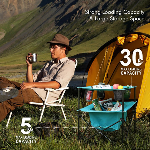 Man relaxing beside yellow tent with blue Lightweight Portable Camping Picnic Table With 4 Cup Holders And Carry Bag, Folding Beach Table