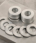 M6 Serrated Spring Washers Locking Stainless Steel 40 Piece Set Rust Resistant stacked and laid out on a metal surface.