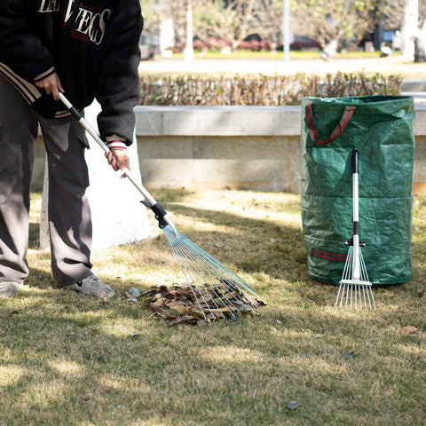 Person using Two Pack Adjustable Yard Rake Set With 63-Inch 15-Tine Big Rake And 30-Inch 9-Tine Small Rake in a garden.