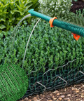 Heavy Duty Galvanized Landscape Staples Kit With 50 U Shaped Stakes 6 Inches Long 11 Gauge Plus 50 Fixing Gaskets And 1 Pick Hook For Weed Barrier Ground Cover Sod Fabric Lawn Decor in use