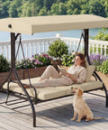 Three Seat Outdoor Patio Swing With Adjustable Canopy And Backrest Convertible Glider Bed On Stand Removable Cushions 45 Degree Tilt For Backyard Poolside Or Balcony 750 Lbs Weight Capacity on a deck with a woman and dog.
