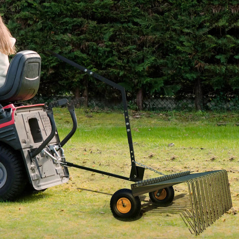 60 Inch Tow Behind Lawn Dethatcher With 24 Heavy Duty Spring Steel Tines attached to a lawn tractor, ready for yard work.