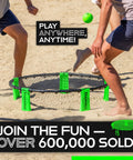 Roundnet Slammo Game Set For Backyard And Beach Fun being played on sandy beach with people engaged in a match.