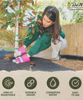 Woman using Workhorse Heavy-Duty 3 Oz Weed Control Fabric Ground Cover for Gardens and Landscaping, Brown, in yard