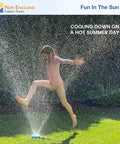 Child playing in water spray from adjustable nine pattern spot sprinkler with heavy duty metal base on a hot summer day.