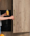 A person using Top Tier Solid Brass Cabinet Pulls With Brushed Gold Finish to open a kitchen cabinet.