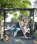 2 In 1 Convertible Porch Swing Bed For Three With Wicker Armrests And Adjustable Canopy, woman reading book on swing