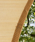 Close-up of Beige Triangle Shade Sail 10 Feet By 10 Feet For Patio Deck And Garden Made From 200 GSM HDPE Water And Air Permeable Fabric