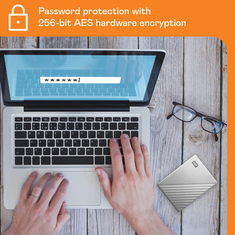 Person using laptop with 2TB My Passport Ultra Portable External Hard Drive With Ransomware Defense and Password Protection