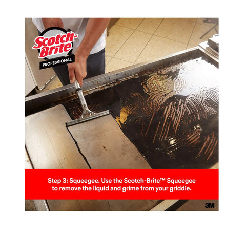 Person using Scotch-Brit Quick Clean Griddle Cleaning System Starter Kit With Squeegee Scraper on griddle surface.