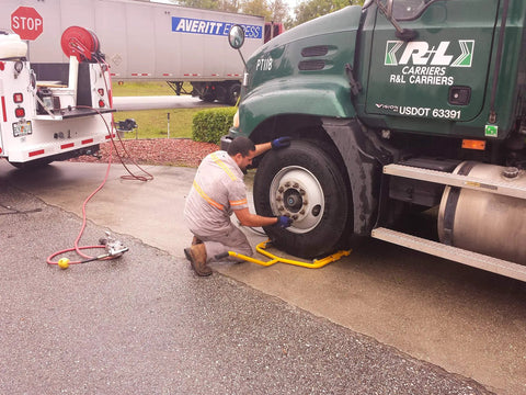 Super Single Truck Wheel Dolly Built With Heavy Gauge Steel And A Low Profile Base For Hauling Massive Otr Trailer Tires Around The Yard Without Breaking A Sweat in use on a truck tire.