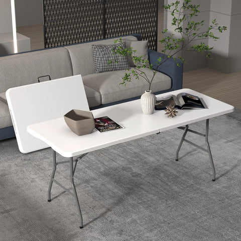 Six Foot Folding Table For Indoor And Outdoor Use Your Go To Portable Plastic Dining Table With Carrying Handle For Picnic Party Camping White Durable One Point Six Inch Thick HDPE Top Waterproof Scratch Resistant Fold In Half For Easy Storage And set up in living room with decor