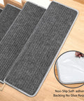 Grey Stair Tread Carpet Runner Set with Adhesive Backing and Nonskid Grip, 9.5 by 30 by 1.2 inches, shown on stairs.