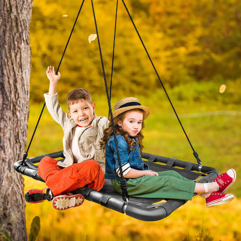 Children enjoying Outdoor Platform Swing For Kids With Rectangular Mat Chair For Tree Or Swing Set Playground Includes Accessories 40 By 30 Inches Black Rectangle Built For Safe Indoor Or Outdoor Fun For Hangouts And Playdates, in a fall setting.