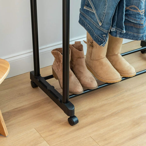 Heavy Duty Double Rod Clothes Rack With Smooth Rolling Lockable Wheels And Height Adjustable Extendable Bar showcasing tan boots on shelf.