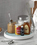12 Inch Lazy Susan Turntable Organizer Featuring Slick Spinning Heavy Duty Ball Bearings And Nonskid Base For Kitchen Pantry Bathroom Cabinet And Craft Room Storage Tray To Keep Your Setup Tight with jars of honey, baking powder, and vanilla extract.