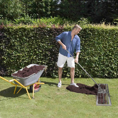 Effortless Lawn Leveler Tool For Fast Ground Leveling stainless steel yard rake used in garden with wheelbarrow and soil