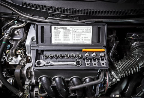 Engine bay with Serpentine Belt Tool Set 15 Pc With Locking Flex Head Ratcheting Wrench and box on top of engine parts.