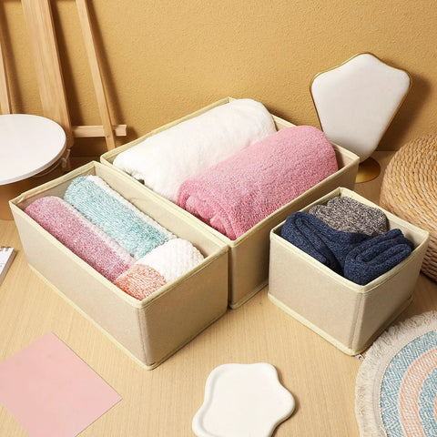 6 Piece Underwear Drawer Organizer Set Features Fold Flat Storage Bins with colorful rolled towels in beige bins on a wooden table.