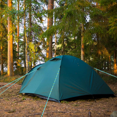 Half Inch By Hundred Feet Arborist Tree Climbing Rope Forty Eight Strand Polyester Static Bull Line in a forest with a camping tent.
