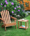Solid Acacia Wood Side Table With Two Tier Storage For Indoor And Outdoor Use No Fuss Assembly End Table For Living Room And Patio Weather Resistant Light Natural Rustic Finish next to wooden chair on grass