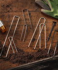 100 Pack 6 Inch 11 Gauge Heavy Duty U Shaped Garden Staples Ground Stakes for anchoring landscape fabric on wooden surface