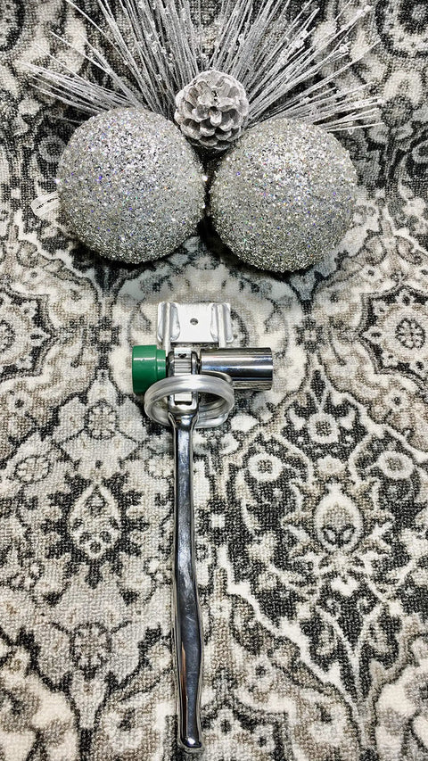 Glittery silver holiday ornaments beside Two Pack Aluminum Silver Tool Holder And Hammer Holder For Carpentry Projects.