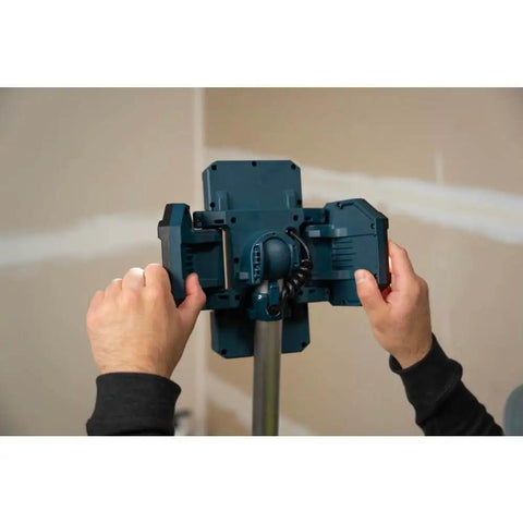 Hands adjusting Powerful 5000 Lumen Cordless LED Tower Work Light With 87 Inch Telescoping Stand for construction and garage use.