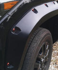 Widebody flare installed with 24 Piece M6 18mm Anodized Aluminum Tapered Washer Kit on a vehicle's front wheel arch