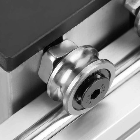 Close-up of an automatic ball screw linear CNC slide table with stepper motor, 100mm stroke aluminum actuator stage, showing wheel detail.