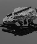 20 Pieces 1/4-20 Button Head Socket Cap Screws Set In 304 Stainless Steel 18-8 Black Oxide on rock surface, showcasing hex drive feature.