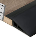Carpet & Floor Edging Trim Strip,Self Adhesive-PVC Floor Transition Strip installed on wood floor with ruler showing height measurement.