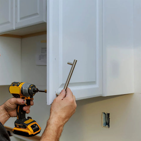 Person using a drill to install cabinet handle with Assorted M4 Cabinet Screws Kit 25 to 50mm Black Zinc Pan Head Phillips Machine Screws 100 Pieces.