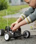 Child adjusting a remote control car outdoors on a concrete surface, showcasing the use of 4mm x 300mm 304 Stainless Steel Solid Round Rod for DIY Craft - 5pcs