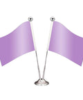 Two small purple flags on a silver base with flagpoles topped by silver balls, isolated on white background.