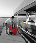 Man using FLO-FAST Pro Pump, 8GPM, to refuel boat dockside with a telescoping draw tube, portable and durable design, made in USA.