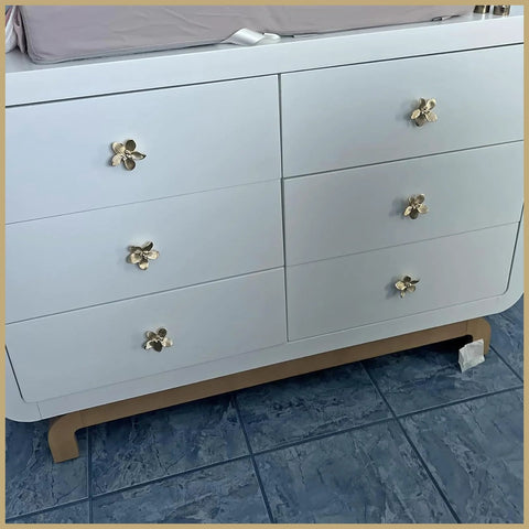 Six Pack 2.4 Inch Gold Flower Cabinet Knobs Set on white dresser showcasing vintage floral petal pulls.
