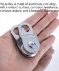 Close-up of a hand holding a 28mm Cable Pulley Wheel with Ball Bearing, Smooth No Noise, Small Snatch Block for 0.23 Inch/6mm Wire Rope.