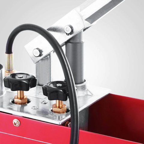 Close-up of hydraulic pressure test pump with 50 bar hand pressure, metal valves, and red steel tank for irrigation and firemen use.